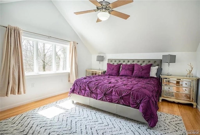 bedroom with hardwood / wood-style floors, ceiling fan, and lofted ceiling