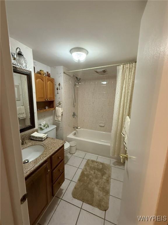 full bathroom featuring tile patterned flooring, shower / bath combination with curtain, vanity, and toilet