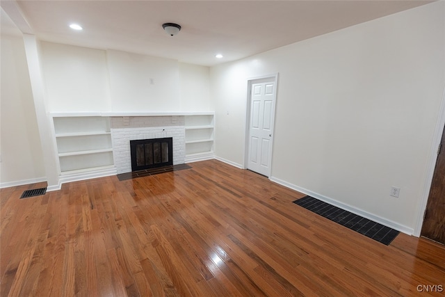 unfurnished living room with wood-type flooring and a fireplace