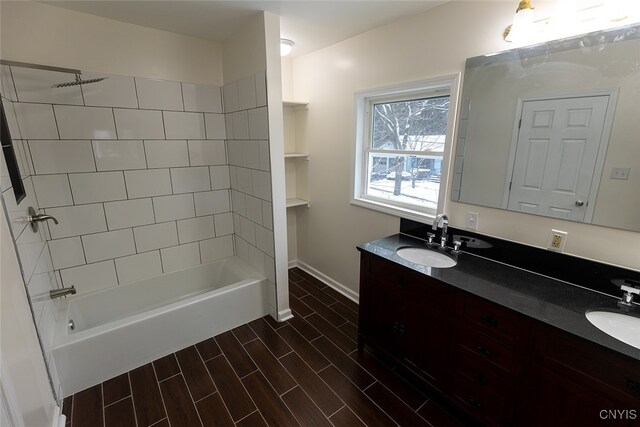 bathroom featuring vanity and tiled shower / bath combo