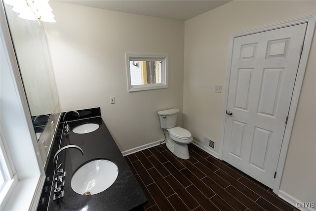 bathroom featuring vanity, hardwood / wood-style flooring, and toilet