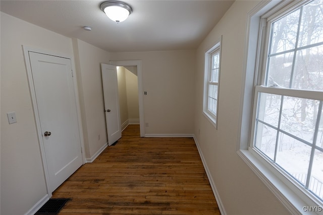 hall with dark hardwood / wood-style flooring