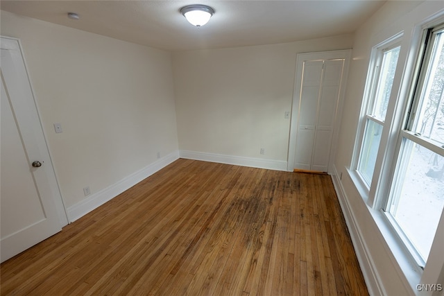 unfurnished room with plenty of natural light and wood-type flooring