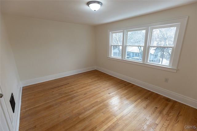 unfurnished room with light hardwood / wood-style floors