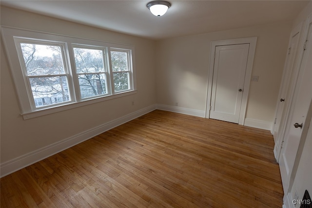 spare room with light hardwood / wood-style floors and plenty of natural light