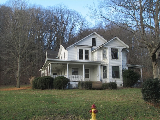 view of front of house with a porch and a front yard