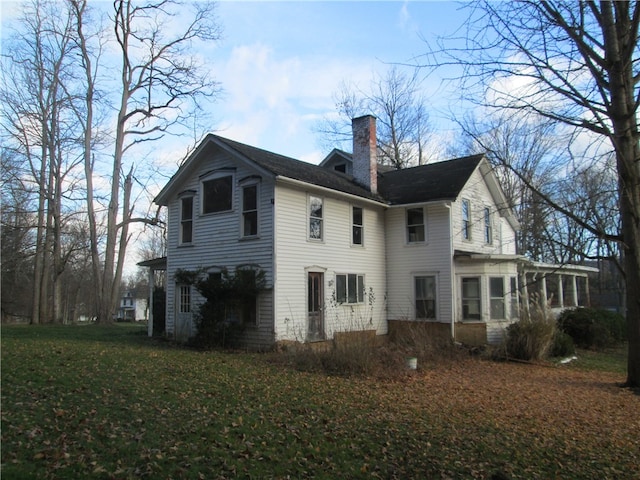 back of property featuring a lawn