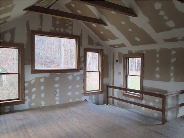 interior space with hardwood / wood-style floors and lofted ceiling with beams