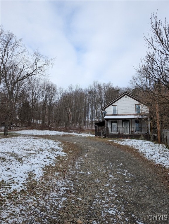 snowy yard with covered porch