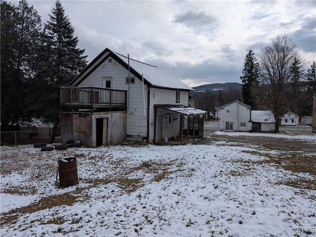 snow covered house featuring a mountain view