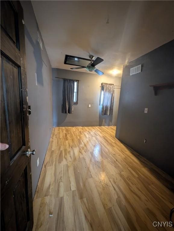 unfurnished room featuring ceiling fan and light hardwood / wood-style floors