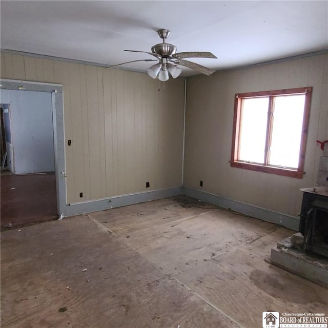 130/118 N Main St, New Albion, NY 14719 - unfurnished living room featuring ceiling fan and a wood stove
