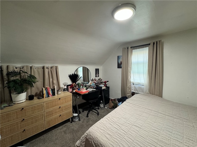 bedroom featuring lofted ceiling and dark colored carpet