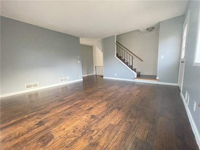 unfurnished living room with dark wood-type flooring