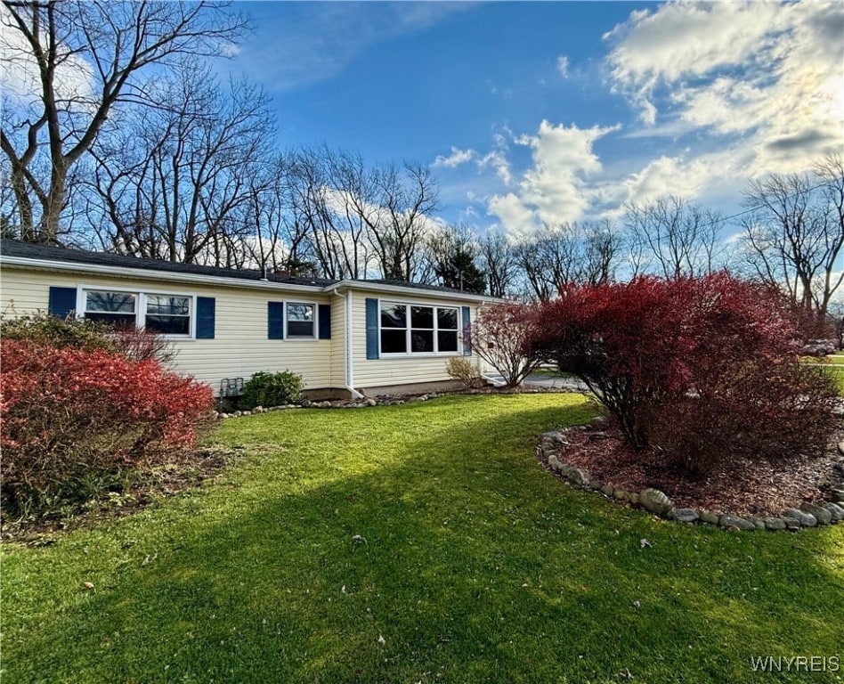 back of house with a lawn