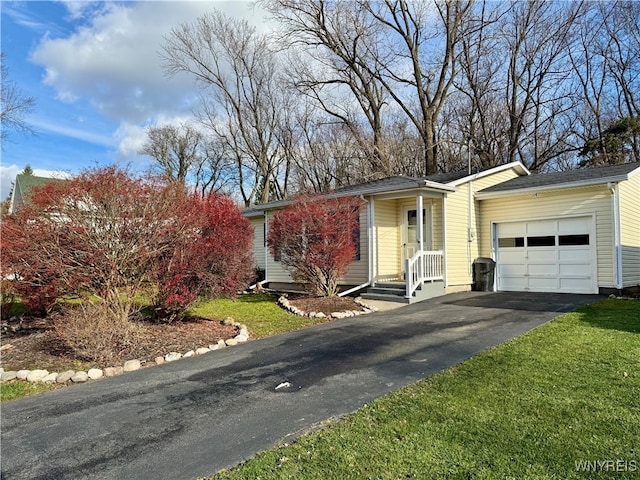 ranch-style house with a garage and a front lawn