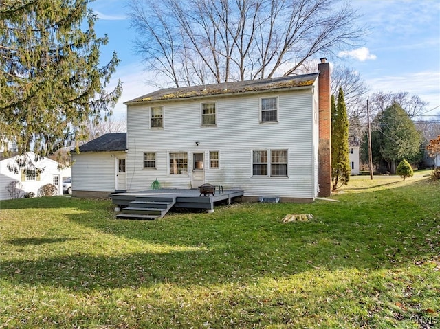 back of house with a yard and a wooden deck