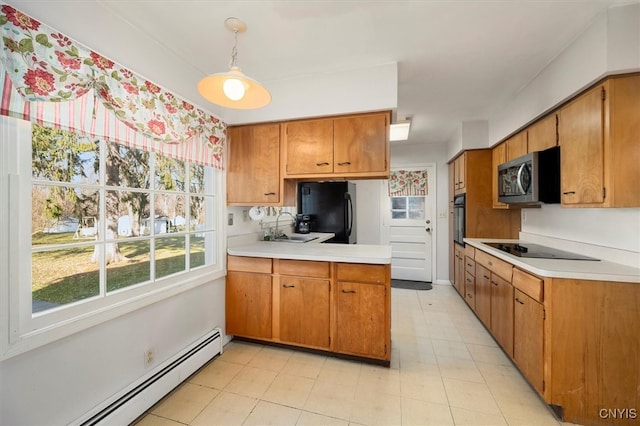 kitchen featuring baseboard heating, sink, black appliances, light tile patterned floors, and hanging light fixtures