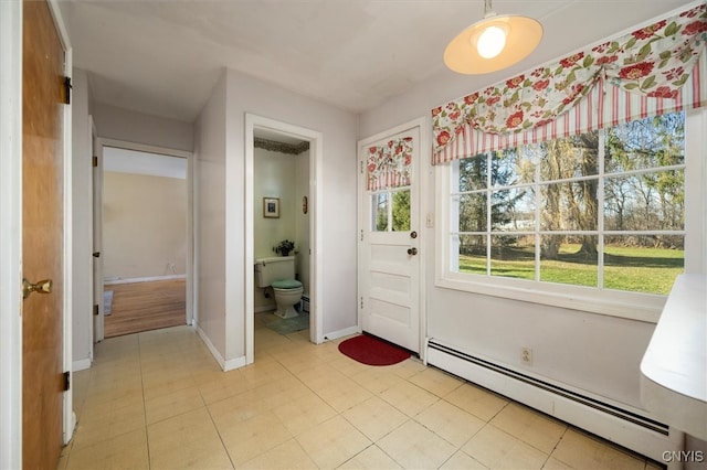 doorway featuring light tile patterned floors and a baseboard radiator