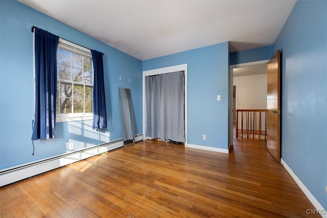 interior space featuring wood-type flooring and a baseboard radiator