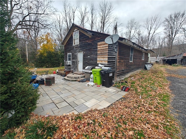 view of side of home with a patio