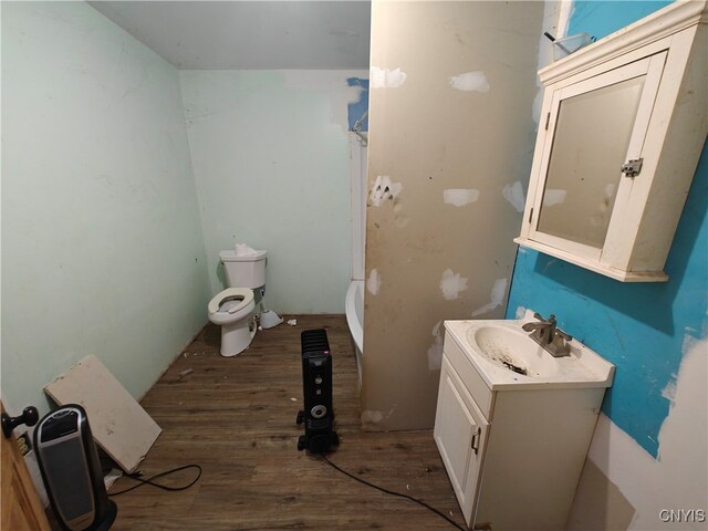 bathroom featuring hardwood / wood-style flooring, vanity, and toilet