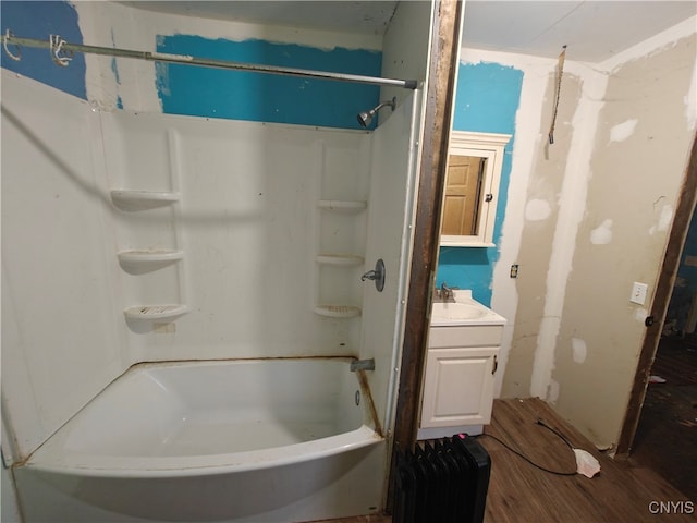 bathroom featuring bathtub / shower combination, vanity, and hardwood / wood-style flooring