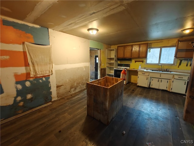 kitchen featuring white range with electric cooktop, dark hardwood / wood-style floors, and sink