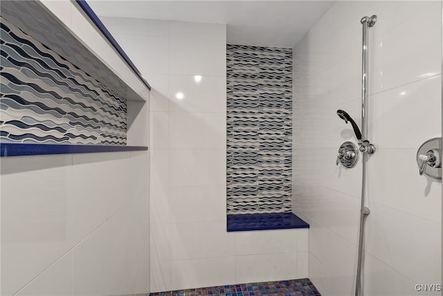 bathroom with tiled shower