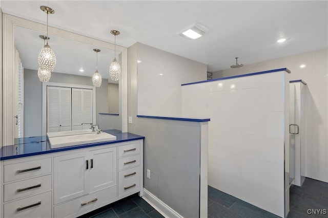 bathroom featuring tile patterned flooring, vanity, and an enclosed shower