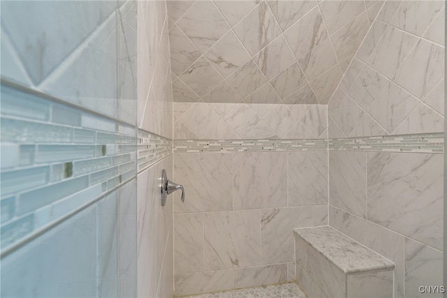 bathroom with a tile shower