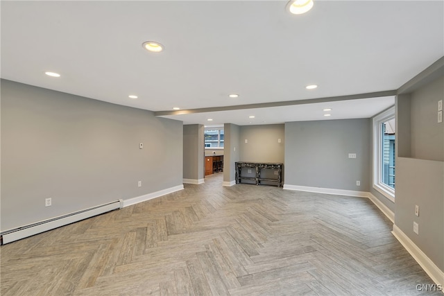 unfurnished living room featuring light parquet flooring and a baseboard radiator