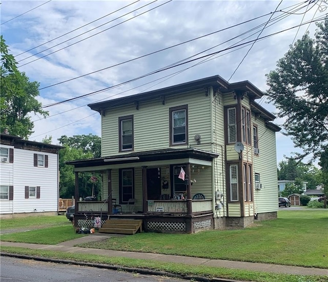 view of front of house with a porch and a front yard