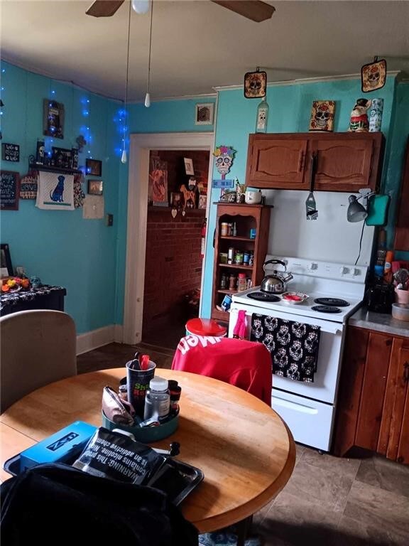 kitchen featuring electric stove and ceiling fan