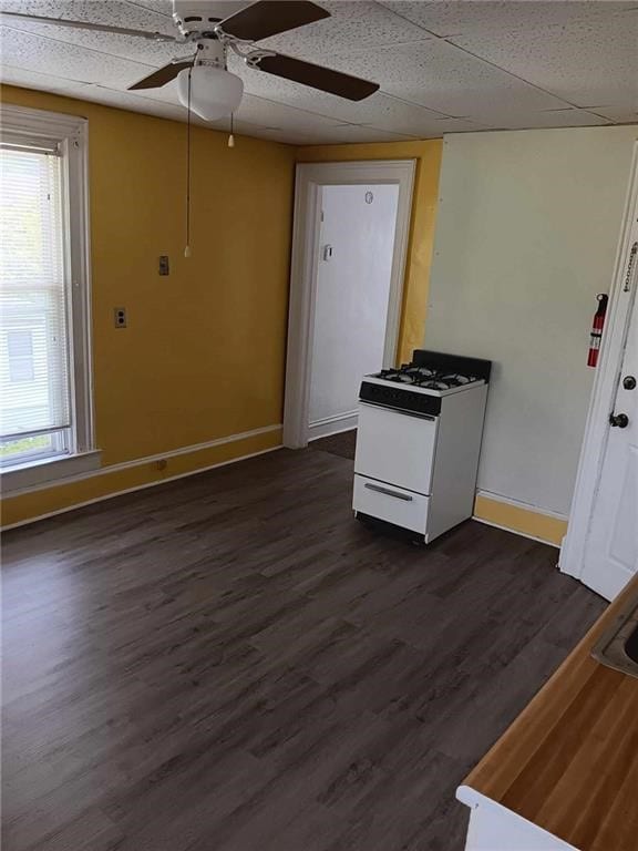 interior space featuring ceiling fan, dark wood-type flooring, and white range with gas cooktop