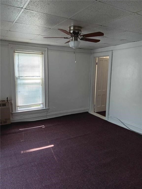 spare room featuring carpet flooring, a paneled ceiling, and ceiling fan