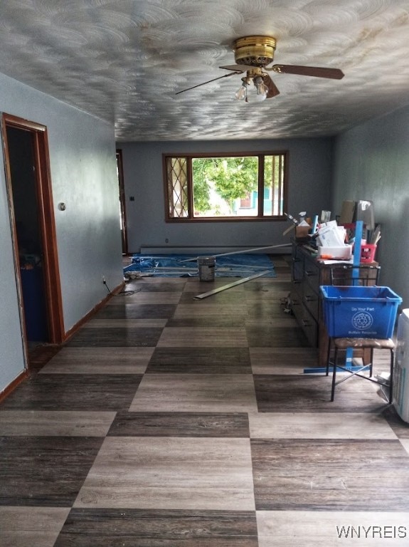 interior space featuring ceiling fan and dark hardwood / wood-style flooring