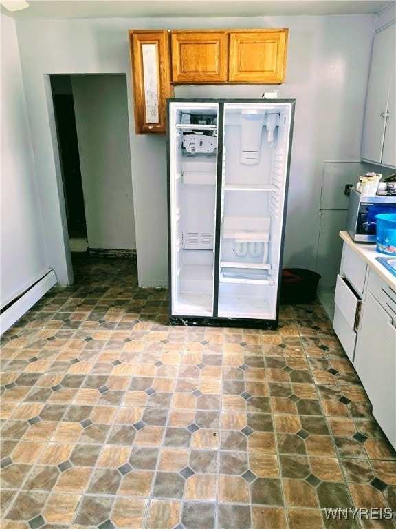 kitchen featuring a baseboard radiator and white refrigerator