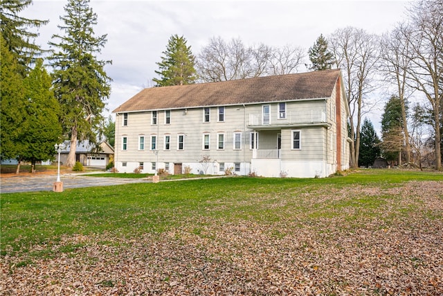 back of house with a lawn