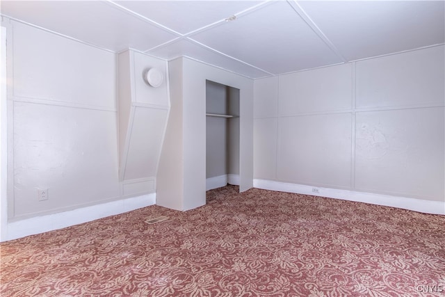 unfurnished bedroom with light carpet and a closet