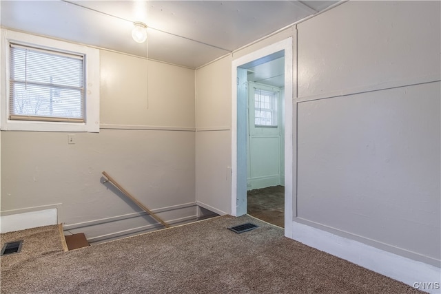 interior space with carpet flooring and plenty of natural light