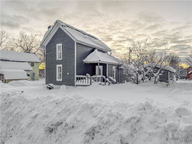 view of snow covered back of property