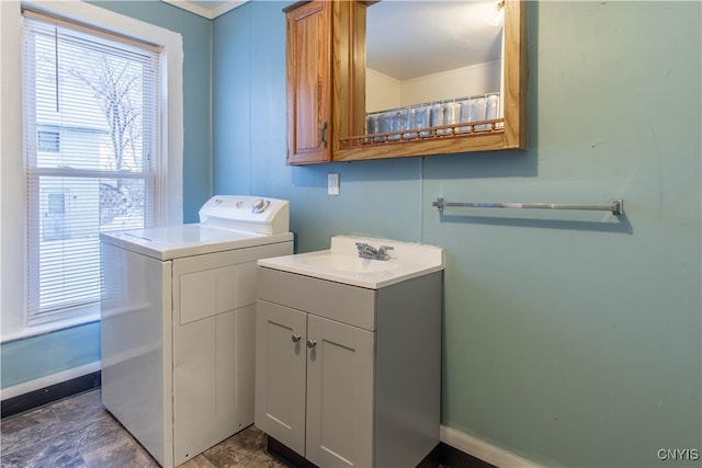 washroom with cabinets, sink, and washing machine and dryer