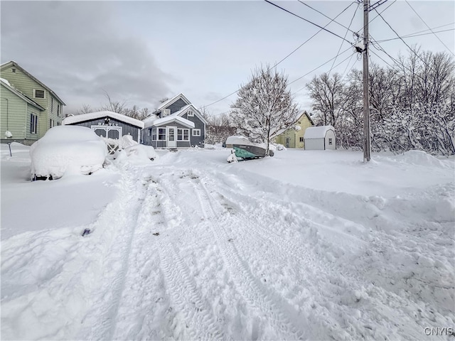 yard covered in snow featuring an outbuilding