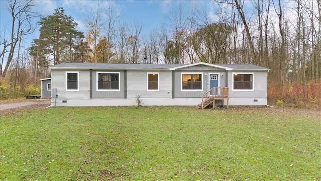 rear view of property featuring a yard