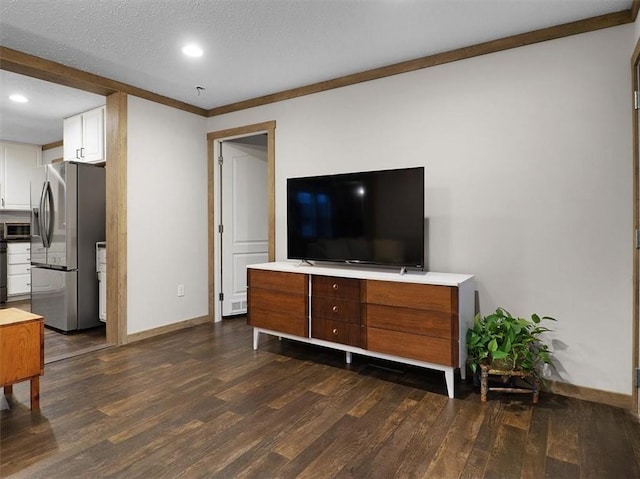 living room featuring dark hardwood / wood-style floors, crown molding, and a textured ceiling