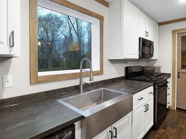 kitchen featuring dark wood-type flooring, white cabinetry, sink, and black appliances