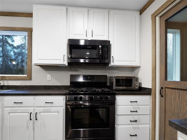 kitchen featuring white cabinets and gas range