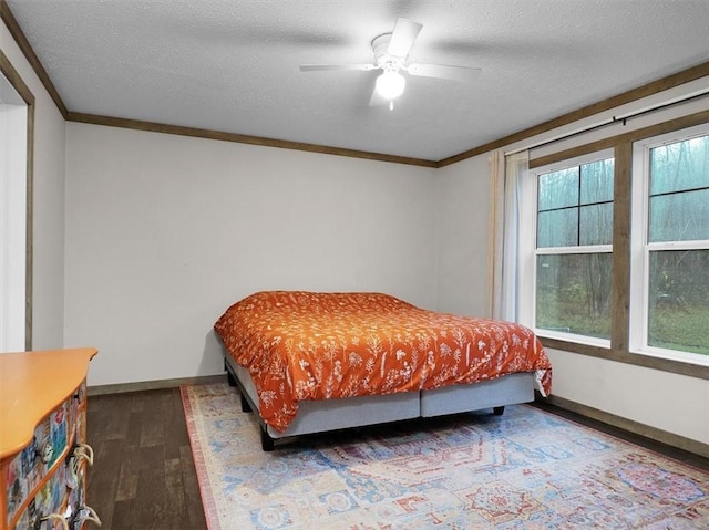 bedroom featuring a textured ceiling, ceiling fan, and crown molding