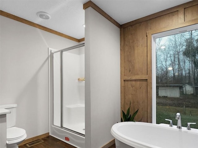 bathroom with plus walk in shower and hardwood / wood-style flooring